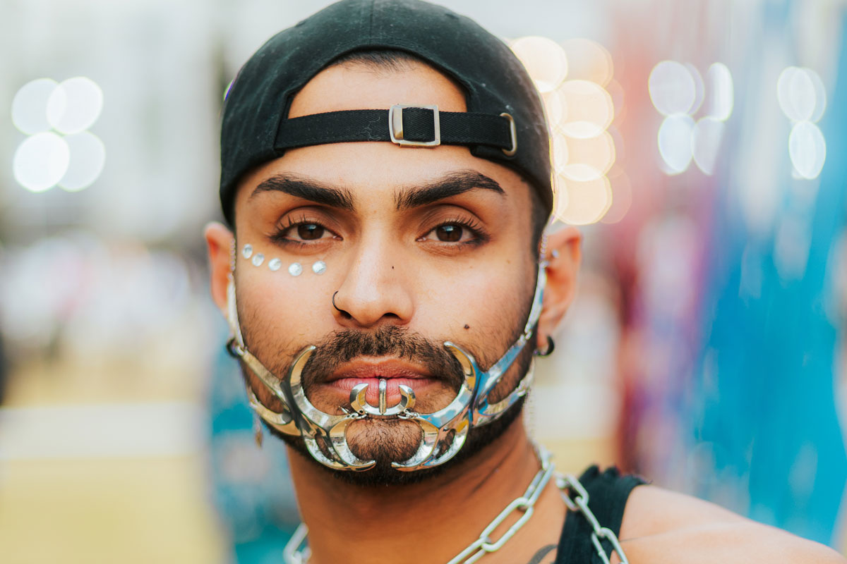 man with hat & face decorations