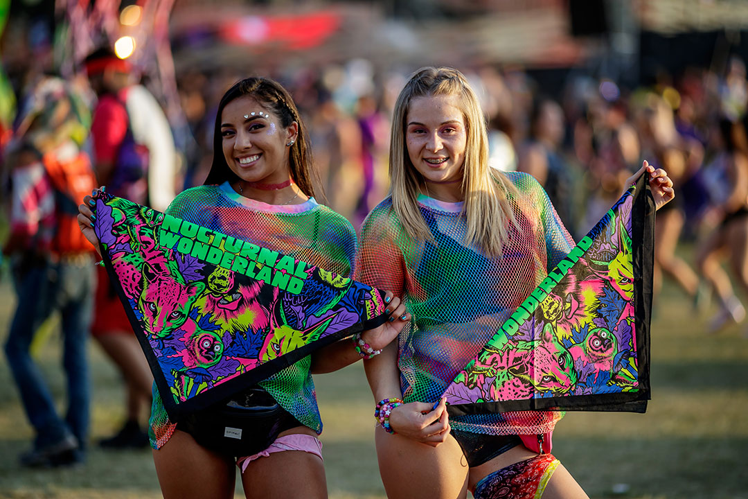 Two girls with Nocturnal Wonderland bandanas