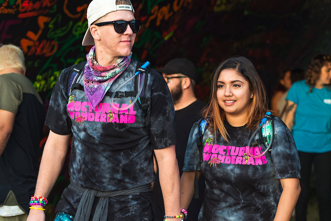 A couple in matching Nocturnal Wonderland T-shirts