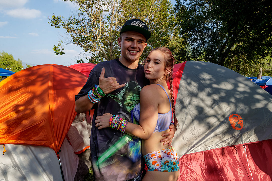 A couple hugs by their tent