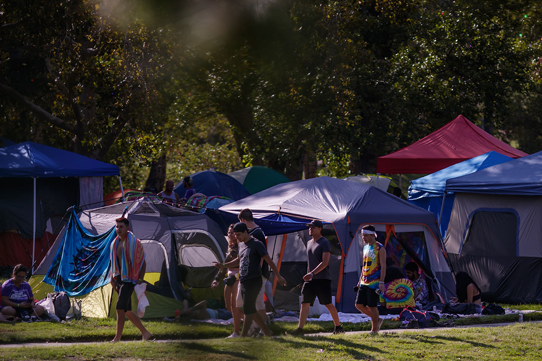 Campers walking past tents