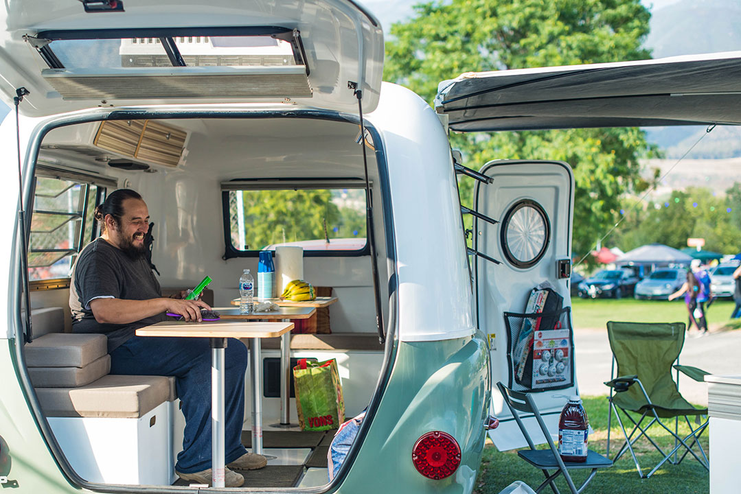 A man hangs out inside a camper van