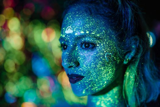A woman with glow paint on her face