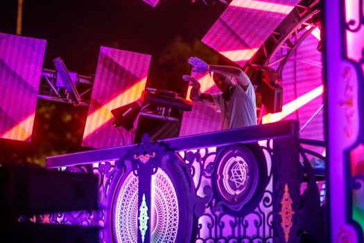 A DJ with his hands in the air