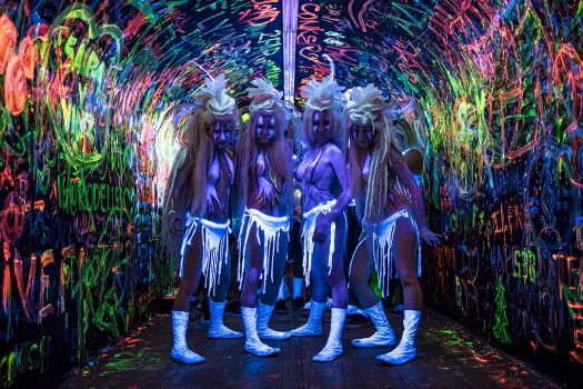 Performers in a graffiti tunnel