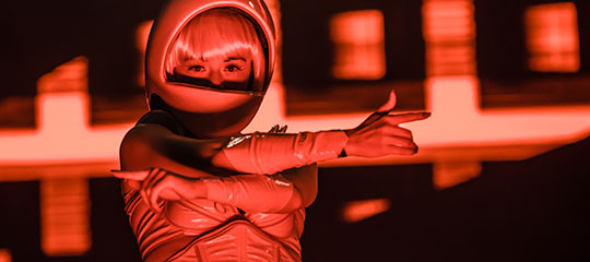 A performer in a space helmet