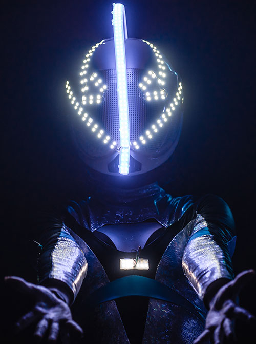 a futuristic performer welcomes you