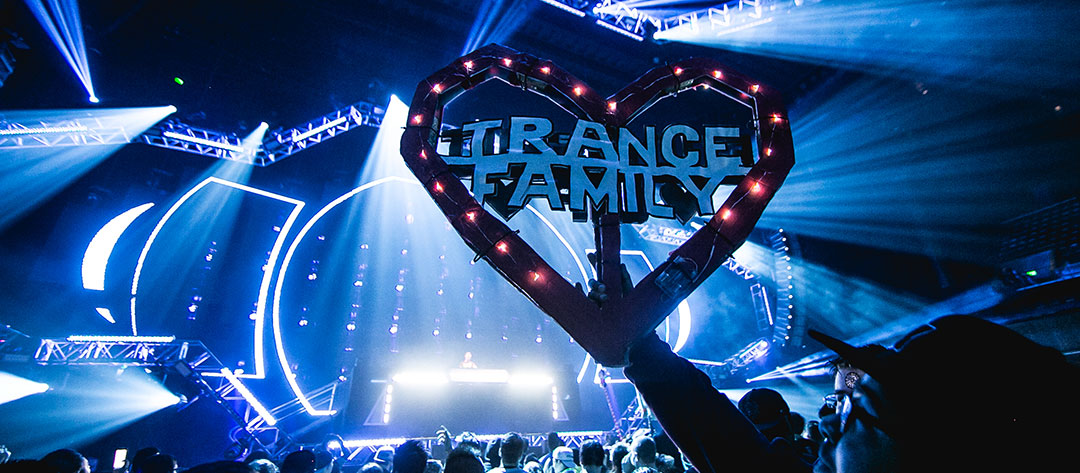 A Headliner holds up a "Trance Family" totem