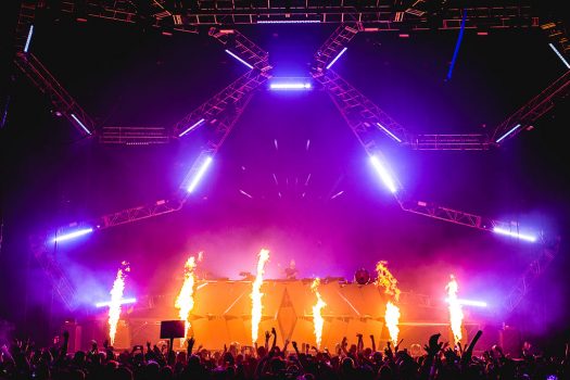Pyro effects shoot off during a DJ set