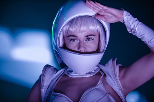 A futuristic performer in a space helmet
