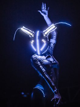 A performer in a glowing helmet