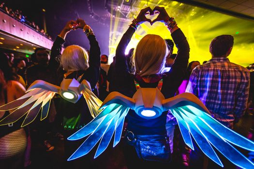 Two girls with glowing wings and heart hands