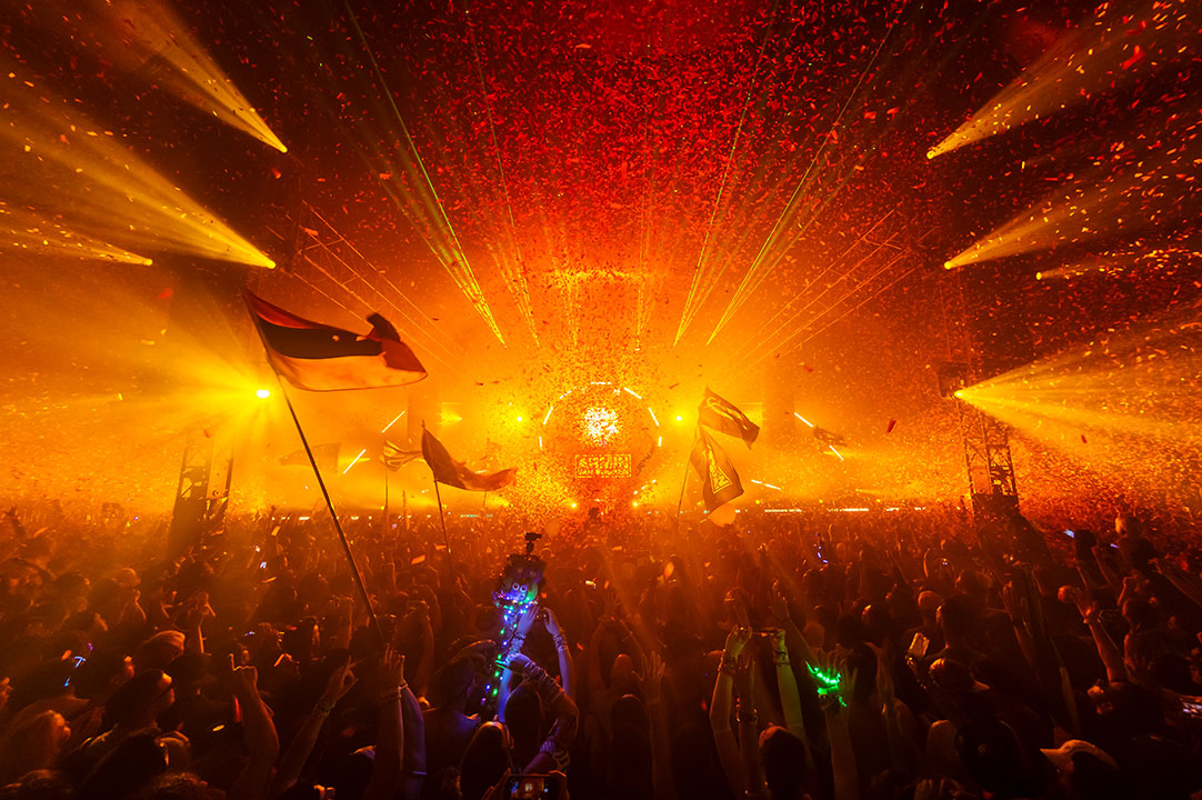 Orange light emanates from the stage