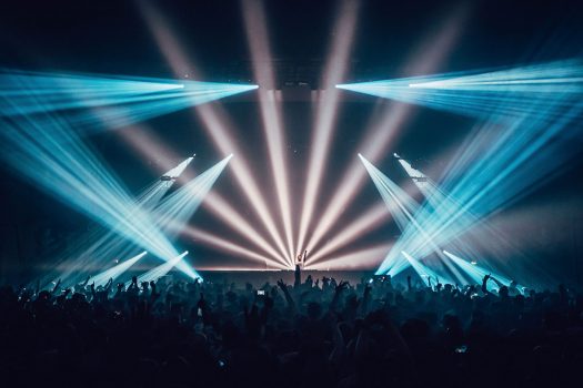 Blue and white lights emanate from the stage