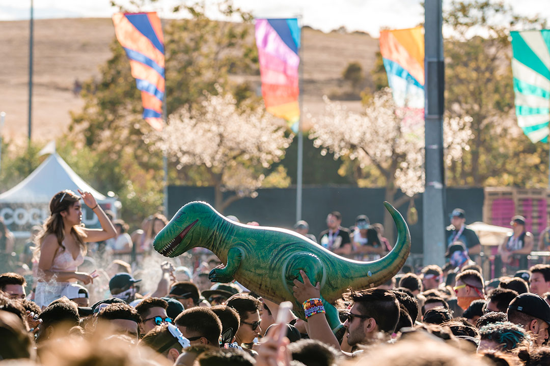 An inflatable dinosaur above the crowd