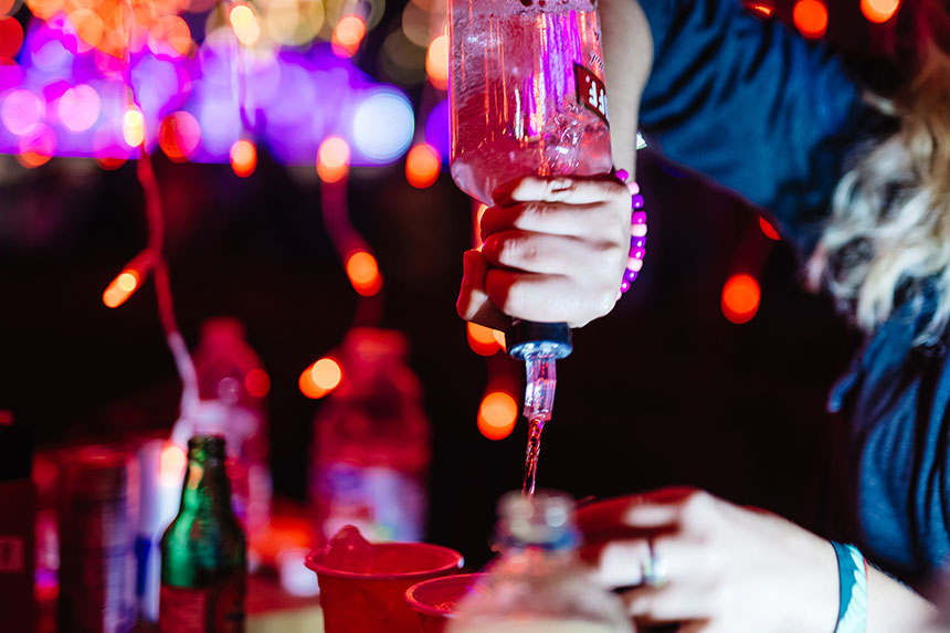 A bartender pours liquor
