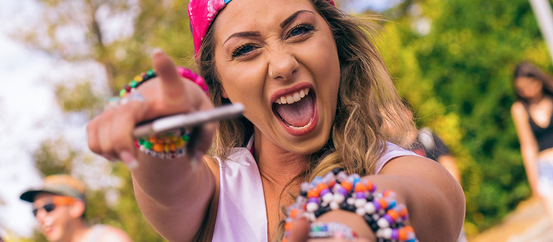 A girl with kandi and a phone