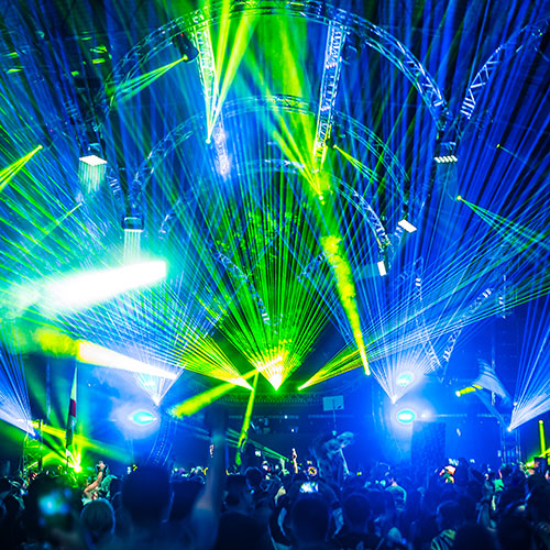Lights from the stage beam over the audience