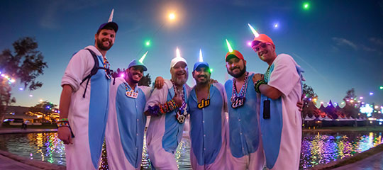A group of men in unicorn onesies