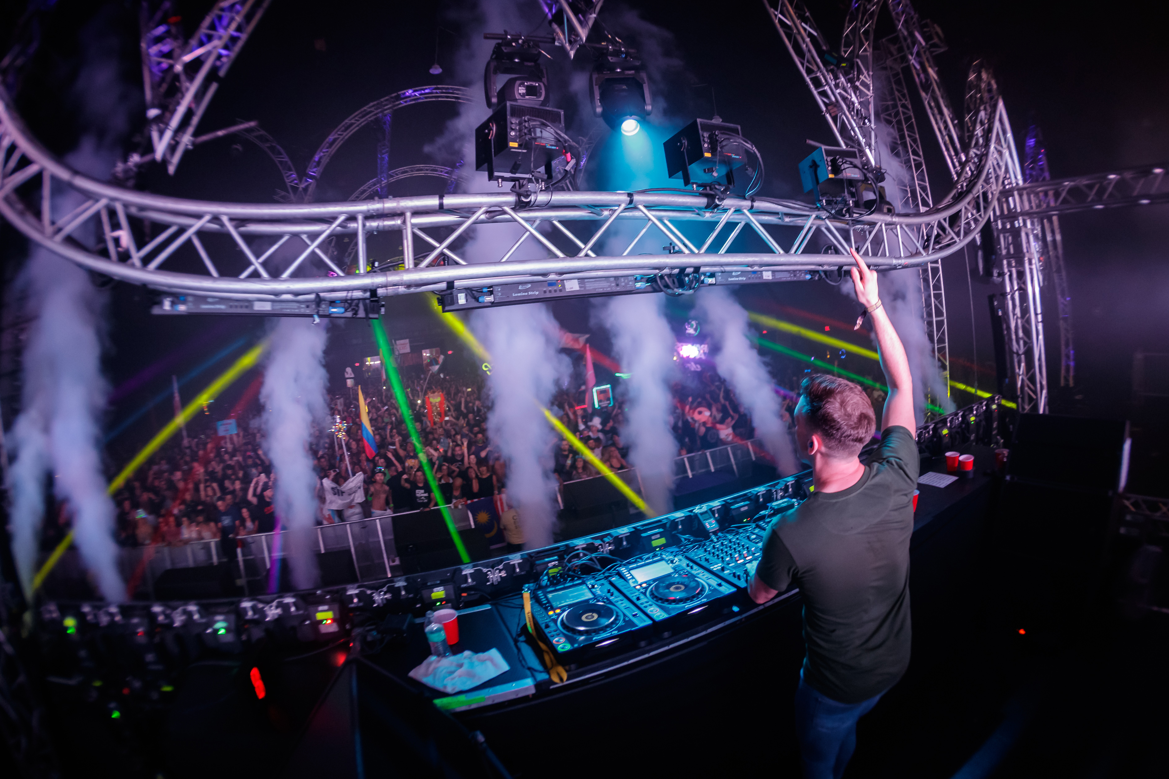 A DJ raises his hand
