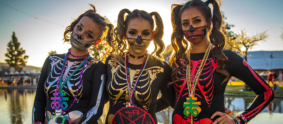 Three girls in skeleton costumes