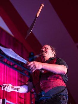 A performer juggling knives