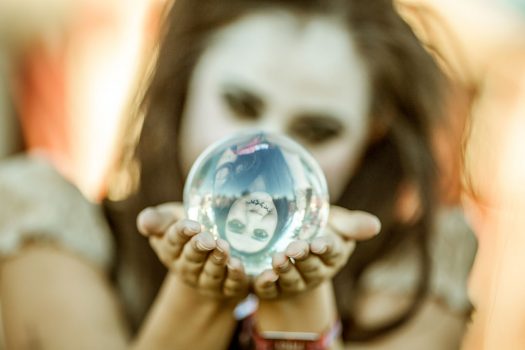 A woman looks into a crystal ball