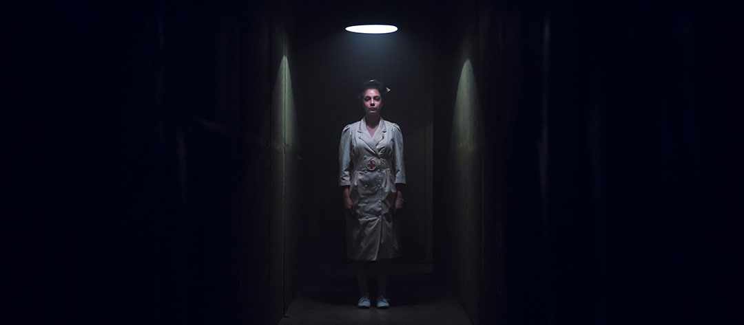 A nurse lurks in a hallway