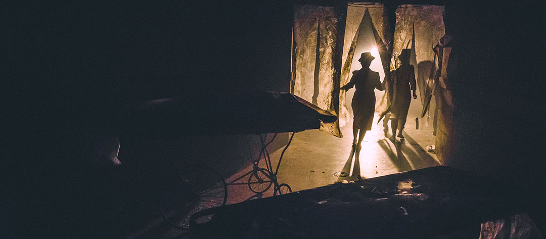 Silhouettes of figures and gurneys