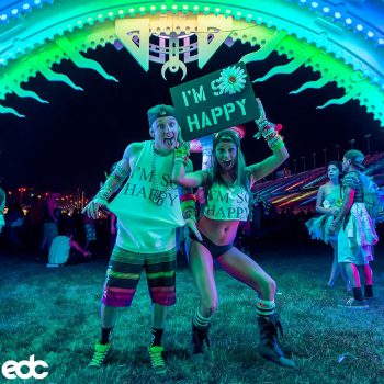 Two Headliners with "I'm so Happy" shirts and totem