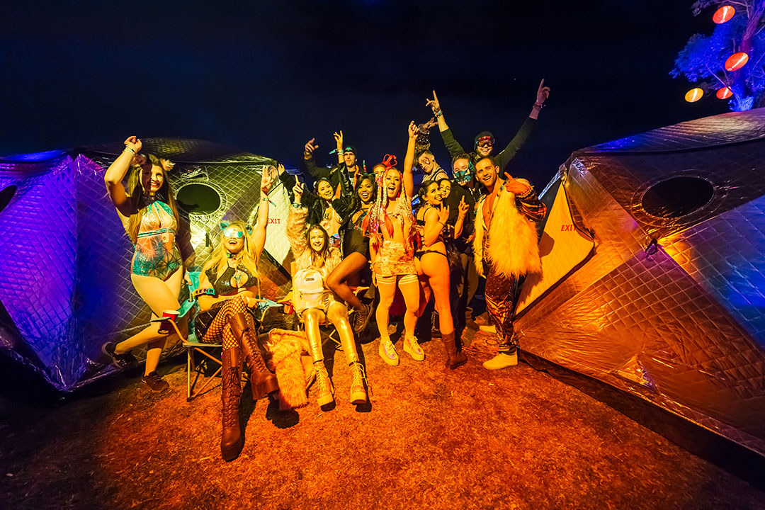 Headliners outside of their ShiftPod2 shelter systems