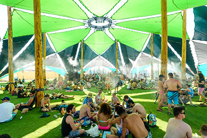 People gathered under a green tent