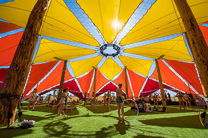 Hula hoopers under a tent