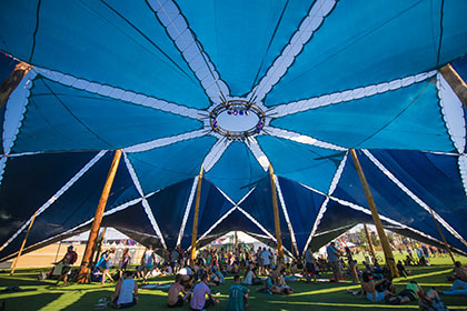 People gathered under a blue tent