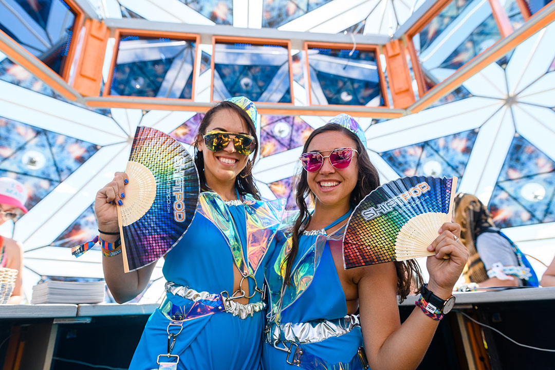 Girls with fans under a tent