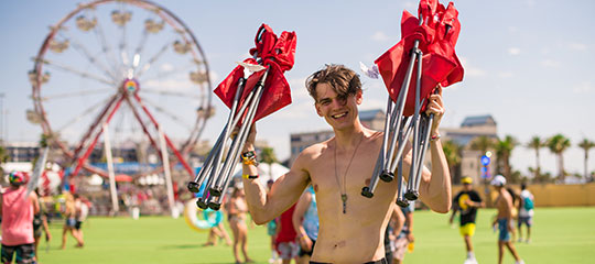 A guy holding camping chairs