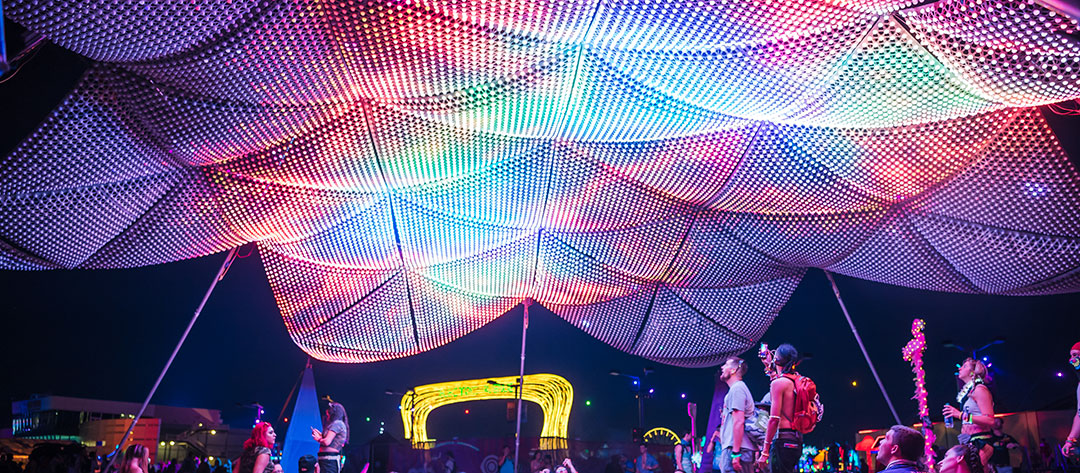 Headliners gaze at a glowing art piece