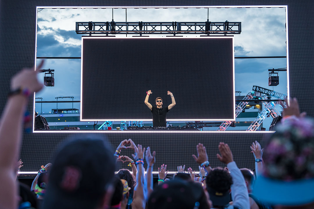 A DJ with his arms up