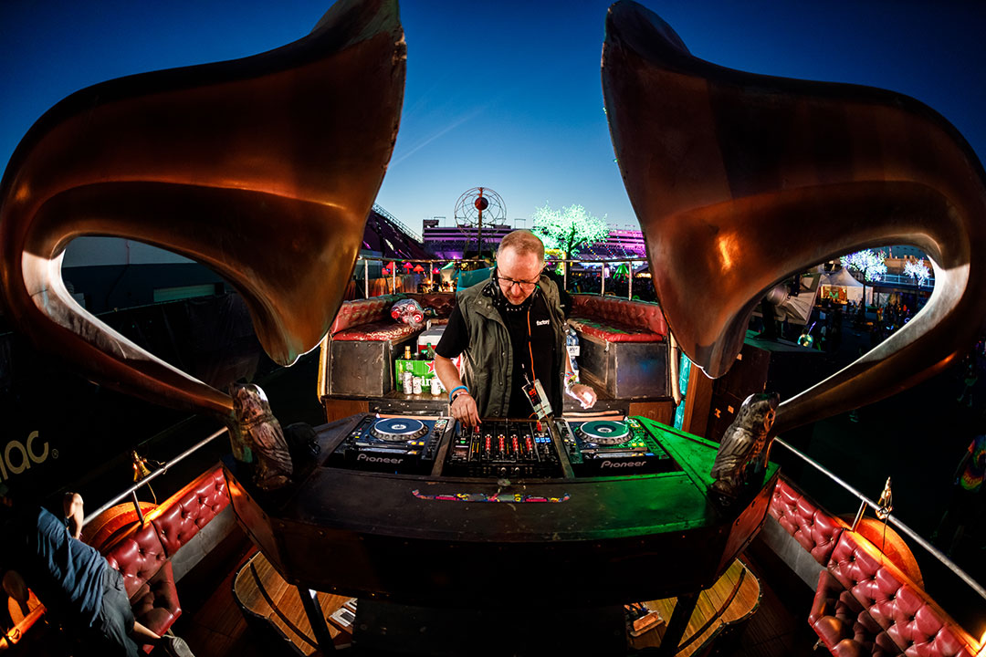 A DJ plays on an art car