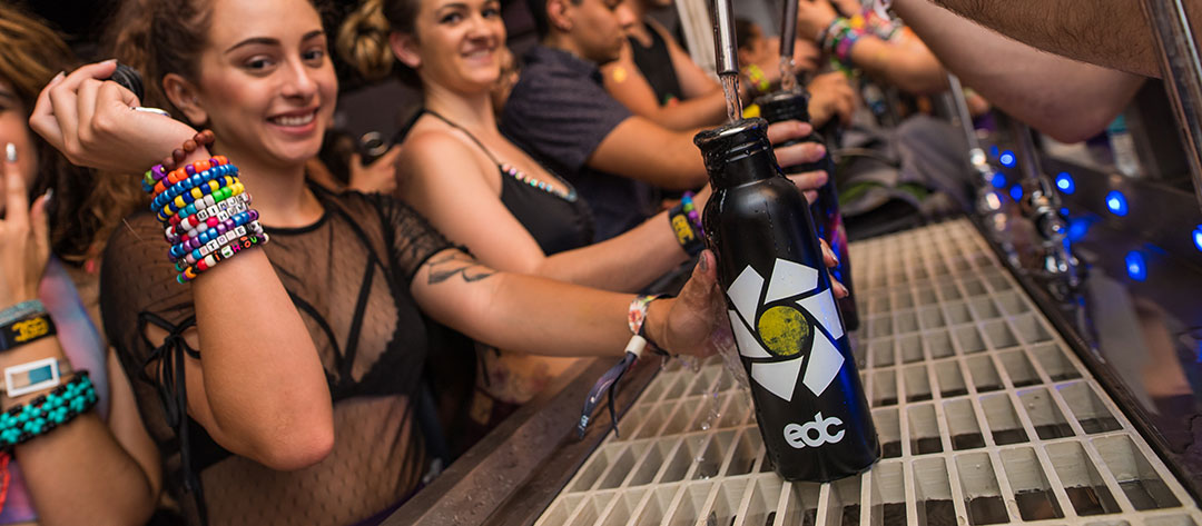 A woman refilling her EDC water bottle