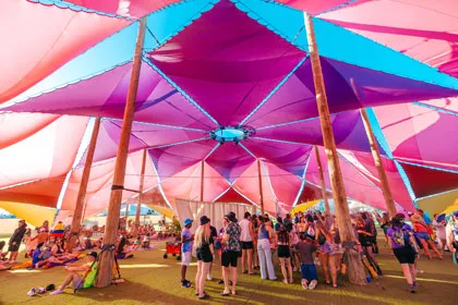 People gathered under a purple tent