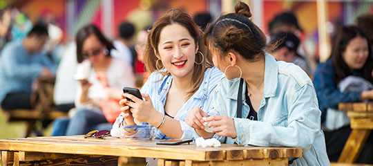 Two women with phones