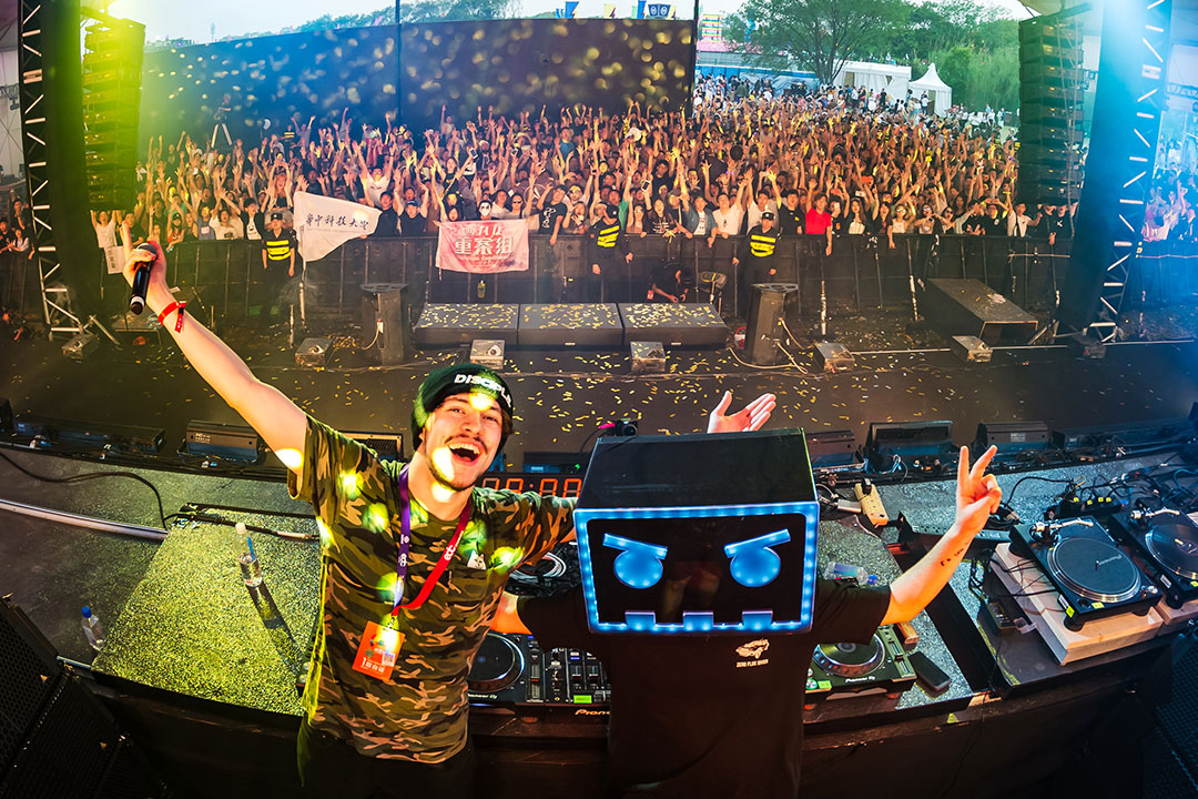 DJs pose in the booth