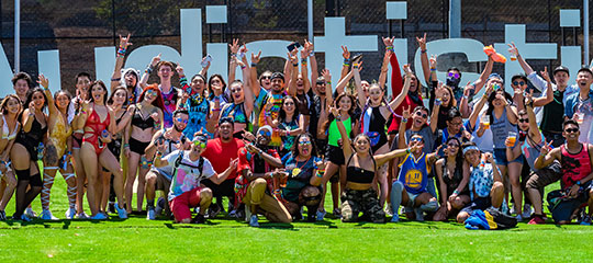 Happy Headliners in front of the Audiotistic sign