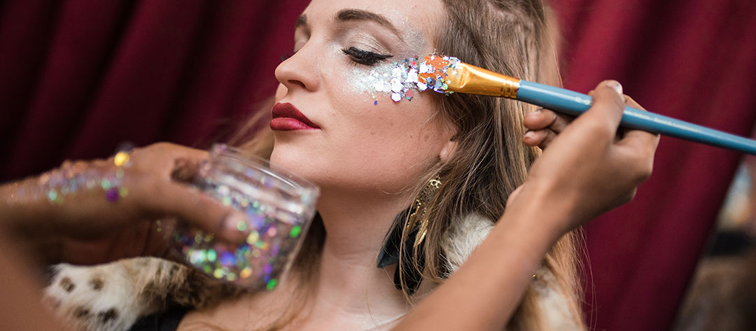A woman receiving glitter makeup