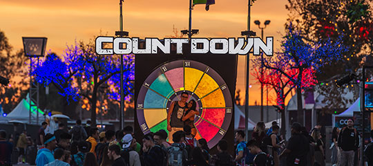 Headliners pose in front of the Countdown sign