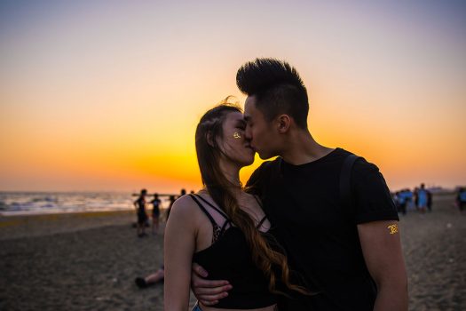 Headliners kiss on the beach at sunset at EDC Japan 2017