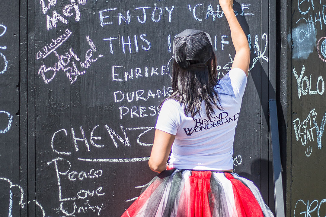 A woman writes on the unity wall