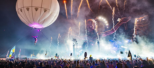 An aerialist hovers over the crowd at kineticFIELD
