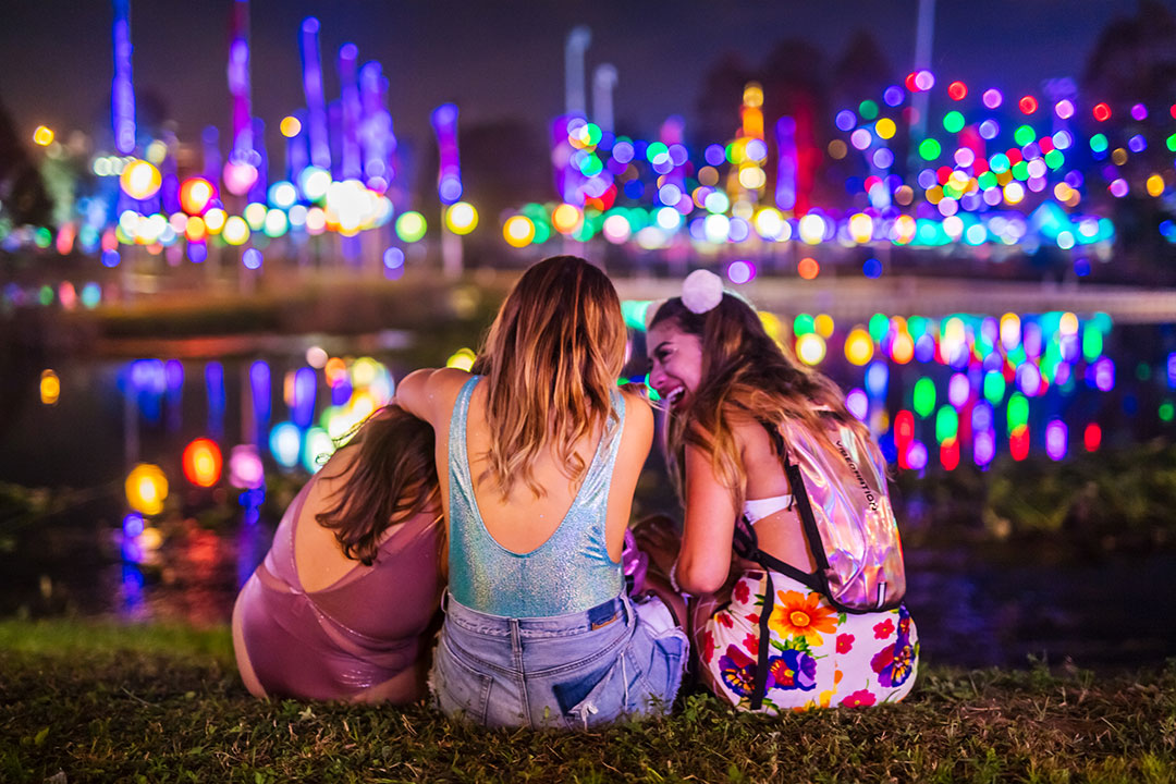 Three girls chill by the pond at Tinker Field